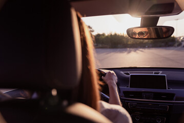 Sticker - Photo of cute charming young woman wear white shirt dark glasses riding car looking back mirror outside city street