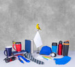 Promo products-Idea Composition-different- rich colors -Thermo mugs-Lanyards Neck Strap-pens-mugs-silver table office clock-notebook-cap-notepaper-tie-glasses-exotic bird-butterfly.On grey desk-wall.