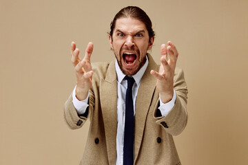 fashionable man emotional man in suit gesture with hands beige background