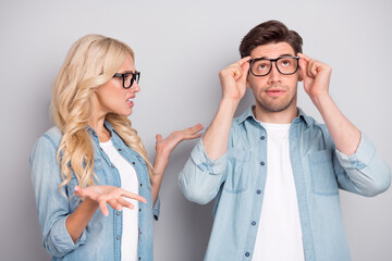 Sticker - Portrait of attractive funky couple guy touching specs girl saying claim isolated over gray pastel color background