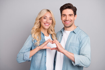 Wall Mural - Photo of adorable sweet young people wear denim shirts showing fingers heart smiling isolated grey color background