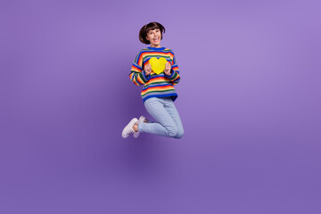 Sticker - Photo of inspired flirty lady jump hold heart card wear striped pullover jeans shoes isolated violet color background