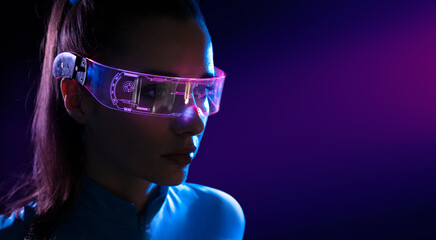 concept of future technology or entertainment system, virtual reality. female portrait lit by hud in