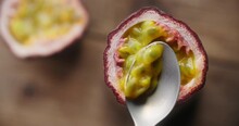 Table Top Video Of Taking Out The Ripe Passion Fruit With Spoon In Slow Motion, Exotic Tropical Fruits Footage, 4k 120fps Prores HQ