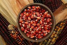 Decorative Indian Corn Seeds In Bowl. Multi Colored Flint Corn On Wooden Background With Copy Space.