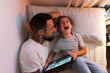 © Milles Studio/Stocksy - Father and son laughing at video