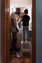 Father And Son Behind Bathroom Door