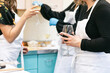 © Sean Locke/Stocksy - Class: Friends Have Wine During Cooking Class