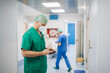 © Daniel Gonzalez/Stocksy - Medic with smartphone in hospital