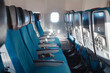 © Anna Berkut/Stocksy - empty seats in airplane, aircraft interior