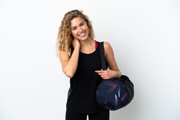 Wall Mural - Young sport woman with sport bag isolated on white background laughing