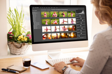 Leinwandbilder - Woman editing digital photos on desktop computer