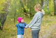 © Ermolaev Alexandr - Mother and little girl with special needs have a fun in autumn park