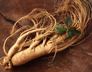 Wall Mural -  fresh ginseng on wooden background