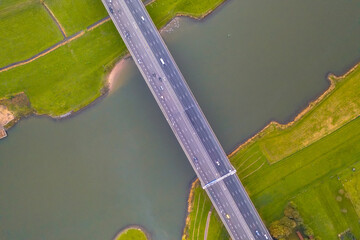 Canvas Print - Lowland river IJssel with highway bridge