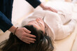 © Fabio Principe - Therapist man doing Holistic therapy Reiki to a woman. Energy treatment with the heat of the palm hands. Japanese energy healing. Wellness, health, relax, well-being and alternative medicine concept.