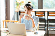 © Q88 - Portrait of Asian businesswoman working in a cafe