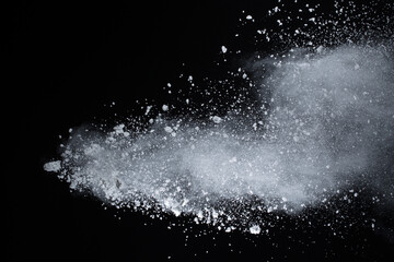 Wall Mural - White powder explosion on black background. Colored cloud. Colorful dust explode. Paint Holi.