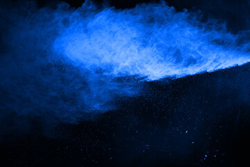 Canvas Print - abstract blue powder splatted background,freeze motion of color powder exploding/throwing color powd