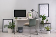 © New Africa - Comfortable workplace with modern computer and houseplants in room. Interior design