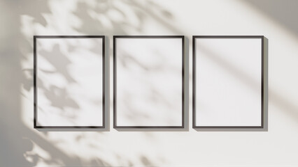 Wall Mural - empty black vertical rectangular frames mock up with leaves shadows and sunlight on white wall backg