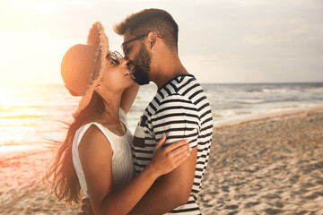 Sticker - Lovely couple kissing on beach at sunset