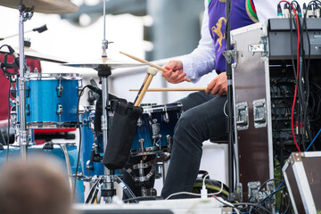 Sticker - Male hands outdoors playing drums with the drumsticks