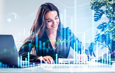 Smiling attractive business woman is making notes and trying to settle a new approach to deal with clients needs to boost the business and achieve exceptional financial results. Overlay bar charts.