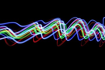 Wall Mural - Long exposure photograph of neon colour in an abstract swirl, parallel lines pattern against a black background. Light painting photography.