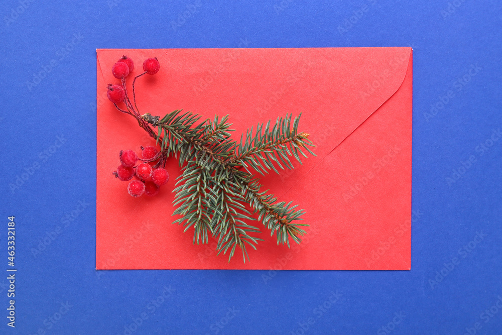 Envelope with Christmas decor on blue background