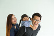 © amorn - Happy Asian family having fun with home. Asian father playing and carrying little daughter on back at home with happy and smile