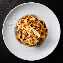 Poster - Tasty fettuccine pasta dish topped with grated cheese on a white plate