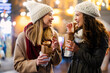 Happy woman friends enjoying time together on christmas market. People happiness concept