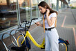 Caucasian young woman pays for bike rental in app