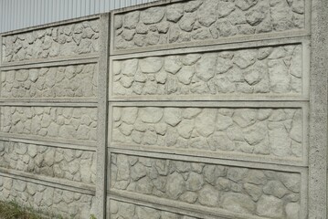 Canvas Print - part of a large gray concrete fence wall in the street