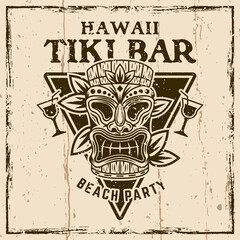 Wall Mural - Hawaiian tiki mask and leafs vector vintage emblem, badge, label, logo or t-shirt print. Illustration on background with grunge textures and frame vector illustration