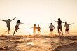 © cppzone - Big group of young friends or big family are having fun and run at sunset beach. Summer vacations concept