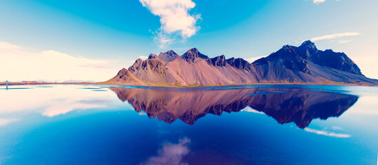 beautiful landscape with most breathtaking mountains Vestrahorn on the Stokksnes peninsula in the mirror of the lake. Exotic countries. Amazing places. (Meditation, antistress - concept).