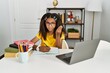 © Krakenimages.com - Young african american girl doing homework at home doing italian gesture with hand and fingers confident expression
