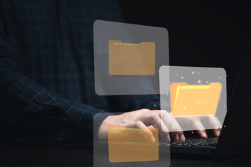 Poster - Businessman using computer laptop with virtual folder graphic for online document database management concept.