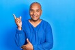© Krakenimages.com - Middle age latin man wearing casual clothes smiling happy pointing with hand and finger to the side