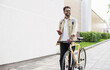 © kite_rin - Young handsome man walking with bike and smartphone in a city, Smiling student men with bicycle and holding mobile phone, Modern lifestyle, connection, travel, casual business concept