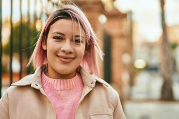 Young hispanic girl smiling happy standing at the city.