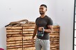 © Krakenimages.com - Young arab man smiling confident training with kettlebell at sport center