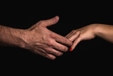 Fototapeta  - A man's hand catching a woman's hand