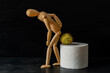 Wooden figure sit on a roll of toilet paper. Concept of the problem with hemorrhoids.