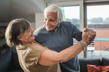 Elderly Couple Dancing At Home