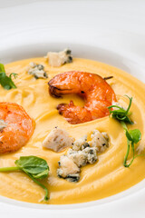 Canvas Print - Autumn food pumpkin soup with shrimps. Served for dinner