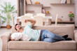 © Elnur - Young man student lying on the sofa at home