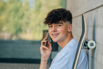 Poster - teenager with mobile phone and skateboard on the street